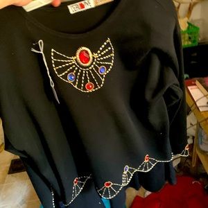 Black top and and a skirt with the front design.